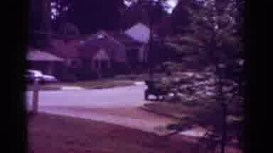 Raleigh North Carolina USA (1962): Two People Stand On The Porch Of A Brick Home