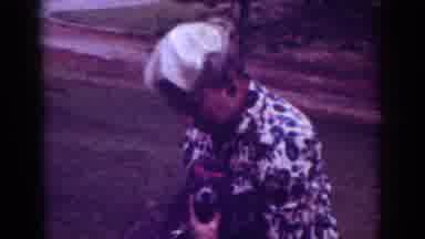 Raleigh North Carolina USA (1962): Woman Wearing Hat Plays With Dog At Roadside