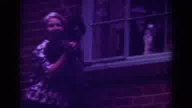 Raleigh North Carolina USA (1962): A Woman Holds A Black Dog To The Window Of A
