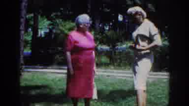 Raleigh North Carolina USA (1962): Woman Shows Her Outfit While Outside To Another