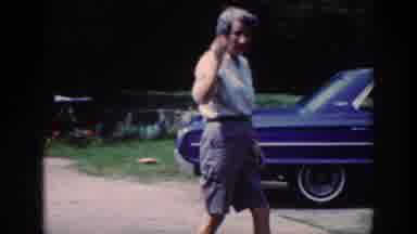 Raleigh North Carolina USA (1962): Older Woman Dressed Like Man Waves Glasses In