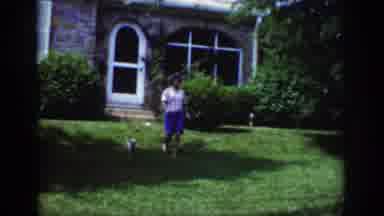Raleigh North Carolina USA (1962): A Woman Walking Toward A Child Sitting On A