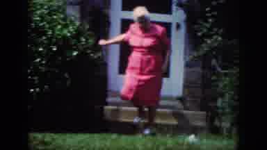 Raleigh North Carolina USA (1962): Woman Wearing Pink Dress Walks Downstairs Girl