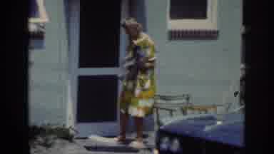 Raleigh North Carolina USA (1962): Woman Holding A Dog On A Porch Attempting To