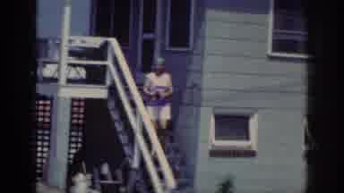 Raleigh North Carolina USA (1962): Woman Wearing Shorts Scarf Walking Down Stairs
