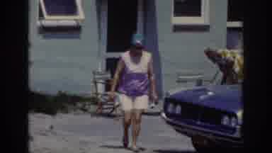 Raleigh North Carolina USA (1962): Woman Covering Her Hair Walking Around A Car