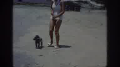 Raleigh North Carolina USA (1962): Lady In White Walking Her Dog On Leash At Beach