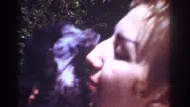 Yorba Linda California USA (1962): A Woman Holds A Small Dog Close To Her Face And