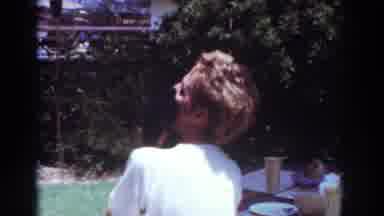 Yorba Linda California USA (1962): Two Small Dogs Frolic Around A Bench While