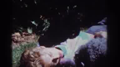 Yorba Linda California USA (1962): Young Lady Laying Down Kissing Her Two Small