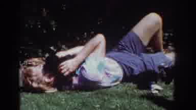 Yorba Linda California USA (1962): Woman Laying On The Grass Playing With Puppys