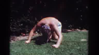 Yorba Linda California USA (1962): Shirtless Man Kneels Over To Kiss Dog Lying On