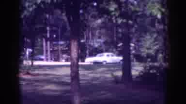 Memphis Tennessee USA (1963): A Car Parked By A Cabin That Is Sitting In A Forest