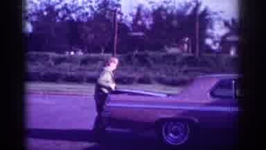 Memphis Tennessee USA (1963): A Woman Opens And Shuts The Trunk Of A Car Parked On