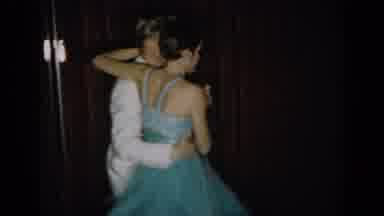 SAINT LOUIS MISSOURI USA-1965: Couple Dancing on Stage with Red Curtain Backdrop