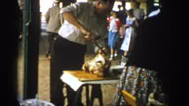 Saint Louis Missouri USA (1965): Man With Knife Cutting Bird In Marketplace With