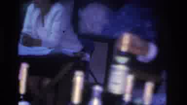Hoboken New Jersey USA (1966): Man Placing Bottle On Table At A Party