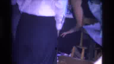 Hoboken New Jersey USA (1966): Clothed Man Putting A Red Round Object In Front Of