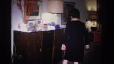 Hoboken New Jersey USA (1966): Woman Wearing Dress Sets Item On Sideboard Top
