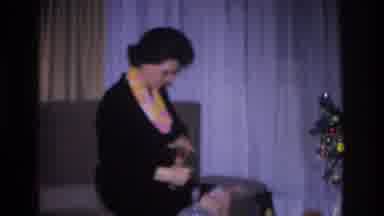 Hoboken New Jersey USA (1966): Woman Unwraps A Christmas Gift