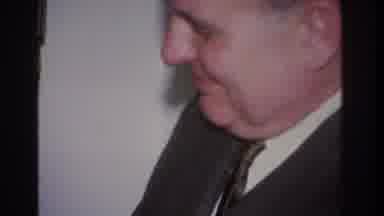 Hoboken New Jersey USA (1966): Amused Individual Conceals Object While Watching