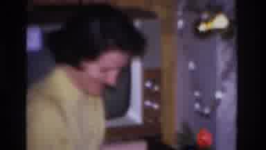 Hoboken New Jersey USA (1966): An Elegant Woman Opening Her Christmas Present By