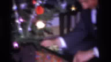 Hoboken New Jersey USA (1966): Sixties Dad Unwraps Present Under Christmas Tree