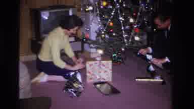 Hoboken New Jersey USA (1966): A Man And A Woman Unwrap Christmas Gifts At The