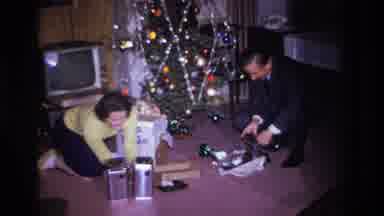 Hoboken New Jersey USA (1966): Couple Opening Christmas Gifts
