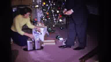 Hoboken New Jersey USA (1966): Well Dressed Couple Opening Their Christmas Present