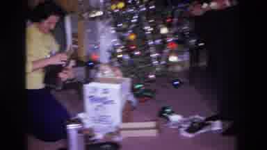Hoboken New Jersey USA (1966): Woman Opening A Christmas Present