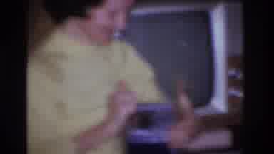 Hoboken New Jersey USA (1966): A Woman In A Yellow Blouse And Blue Pants Opening A