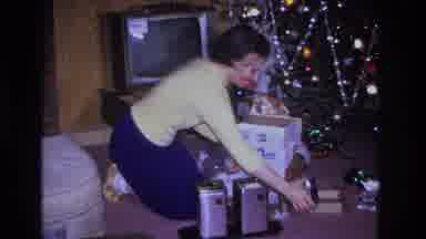 Hoboken New Jersey USA (1966): A Woman Placing A Bow On A Present And A Couple