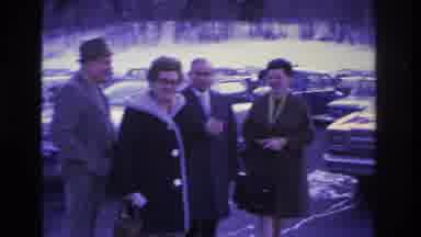 Hoboken New Jersey USA (1966): Woman Kisses Husband In Parking Lot Among Cars In A