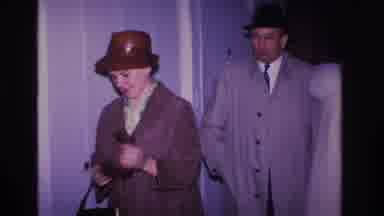 Hoboken New Jersey USA-1966: Man And Woman Arriving From Outside Taking Off Coats And Hats