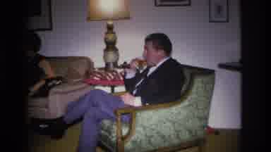 Hoboken New Jersey USA (1966): A Man Sits In A Chair Cross Legged, Drinking And