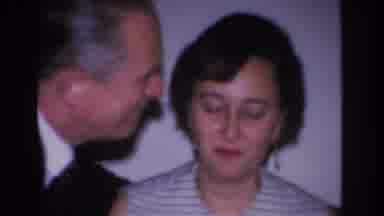 Hoboken New Jersey USA (1966): Man Kisses A Woman's Cheek While Another Grabs A