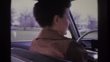 Hoboken New Jersey USA (1966): A Woman Driving While Having A Conversation With