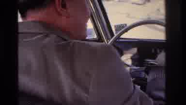 Hoboken New Jersey USA (1966): Man Driving An Old Car Through A Sparsely Populated