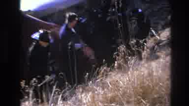 Hoboken New Jersey USA (1966): Men Hat Field Shadow Creepy Grass Weird Box Waving
