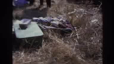 Hoboken New Jersey USA (1966): Two Men Hunched Over The Grass Inspecting Items