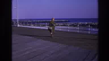 Hoboken New Jersey USA (1966): Woman In Green Coat Yellow Hat Walking On Boardwalk