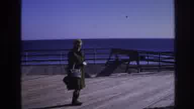 Hoboken New Jersey USA (1966): Woman In Dress And Coat With Purse On Wooden Deck