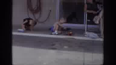 Sacramento California USA (1966): Boys Playing With Toys On Sidewalk By House Back