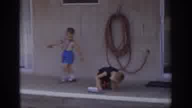 Sacramento California USA (1966): A Little Boy Walks Back And Forth Past Another