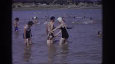 Sacramento California USA (1966): Two Women, A Man, And A Child In The Water, At