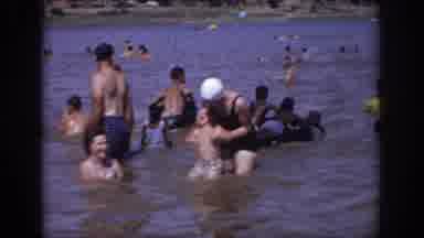 Sacramento California USA (1966): Woman In Swimsuit Dunking Toddler Boy Into Water