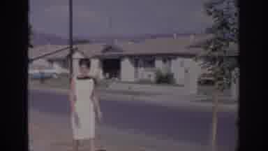 Sacramento California USA (1966): Woman Wearing White Dress Walks In Quiet