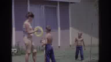 Sacramento California USA (1966): Woman & 3 Young Boys Playing Outside In