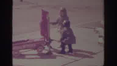 Sacramento California USA (1966): Young Lad Pretends To Fix Toy Car With Flat Tire
